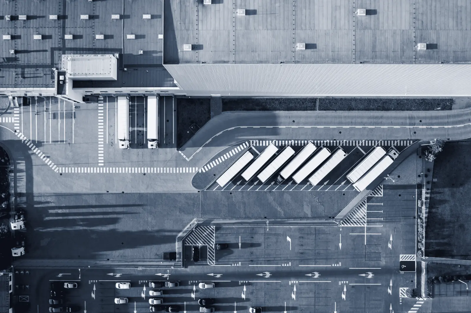 Aerial view of a logistics dock with trucks at the ramps