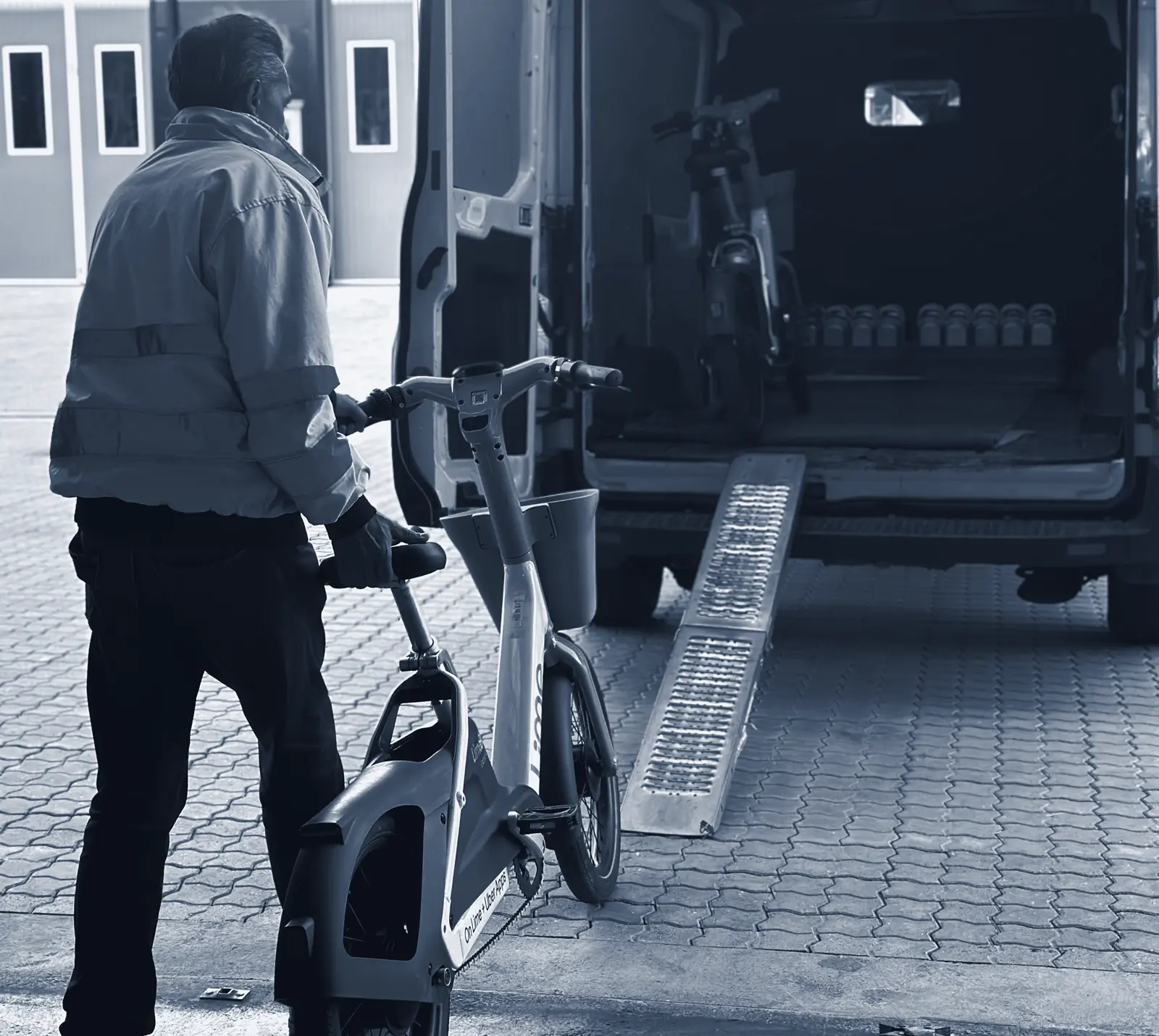 Field technician loading a shared e-bike into a service van